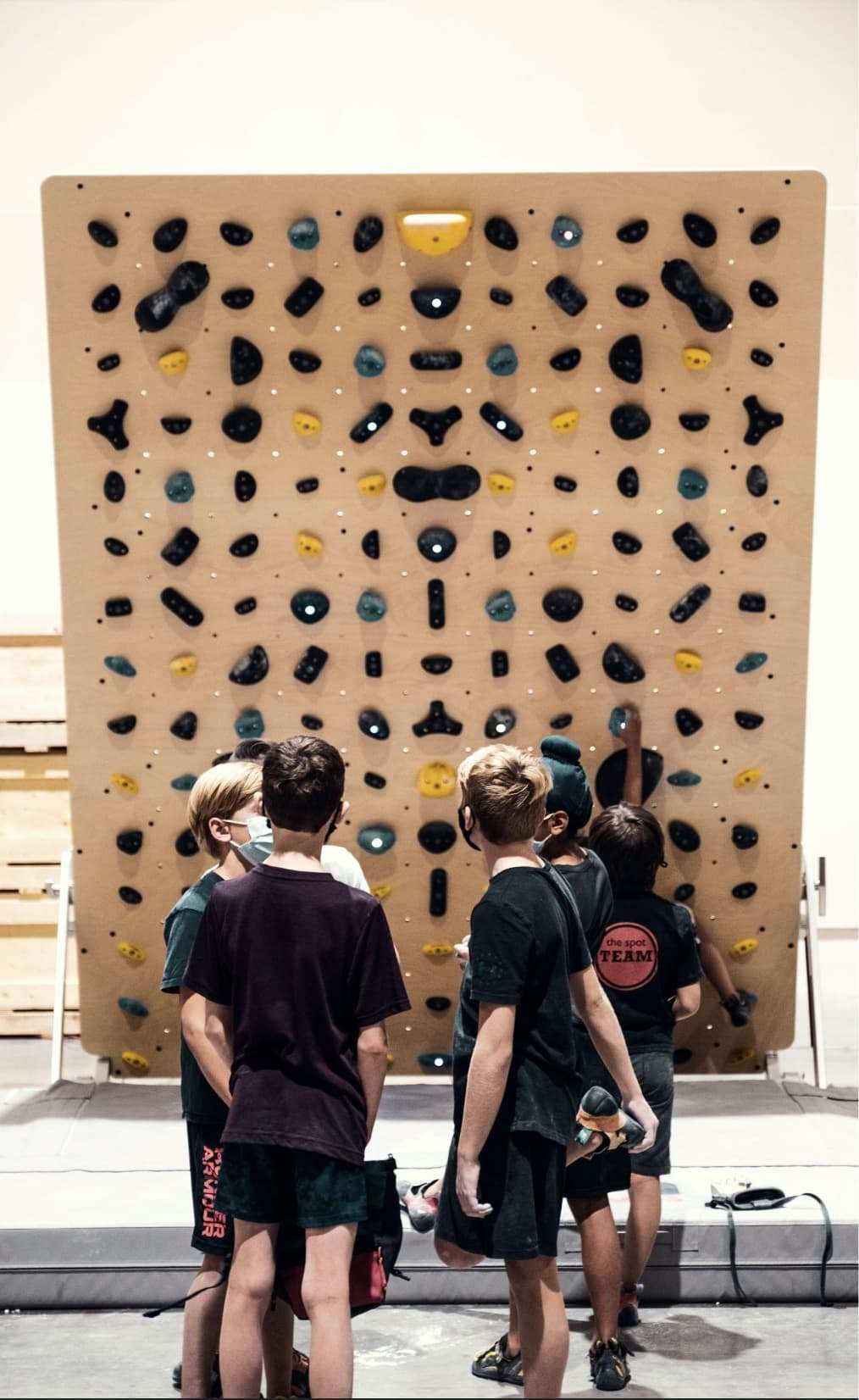 A crowd in front of a competition wall
