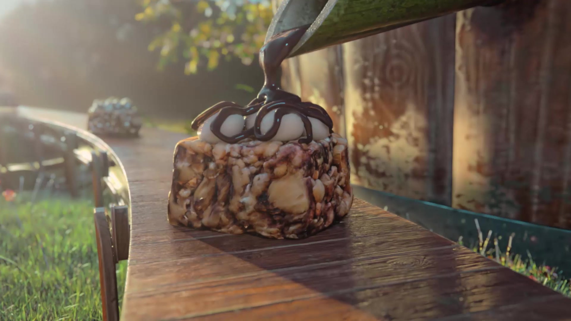 Chocolate pours over a s'mores bite